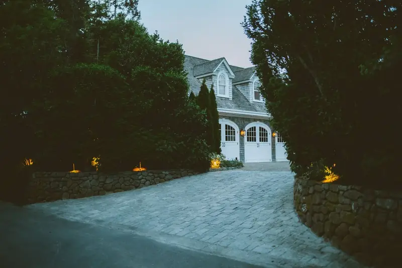 Home at dusk behind a stone wall