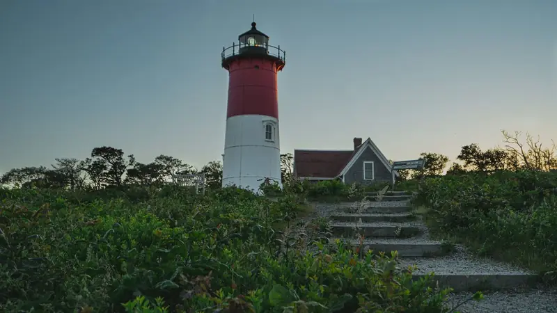 Nauset Light at dusk above a path through the dunes